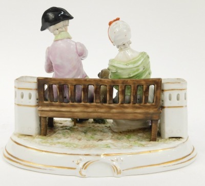 A Continental porcelain figure group, of two figures seated on a bench, depicting male and female with pug, 15cm high, 17cm wide. - 2