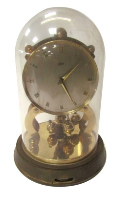 A Junghans Ato brass anniversary clock with a circular silvered