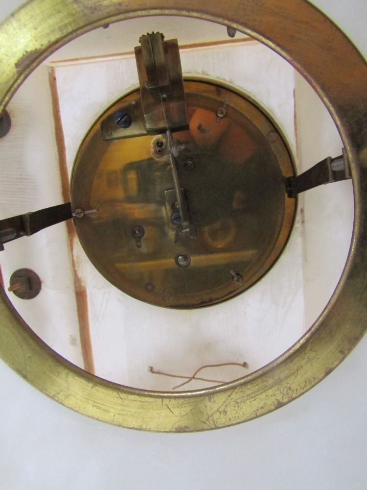 A late 19thC alabaster and ormolu mantel clock, the top with a roaring ...