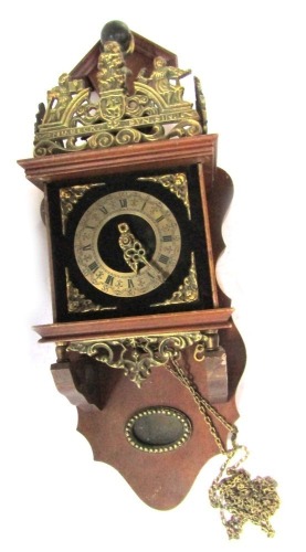 A Dutch Zaandam stoelklok clock, with brass spandrels and a male figure holding ball to striking bell, in a walnut case, 57cm high, 25cm wide.