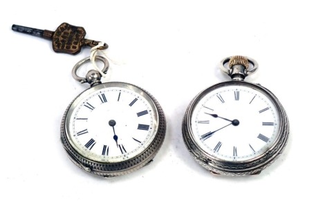 Two silver fob watches, each with heavily embossed floral case, one with vacant cartouche, each with a white enamel Roman numeric dial, key and bezel wind, with seventeen jewel movement, 91.9g all in. (2)