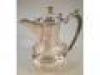 An Anglo Indian white metal hot water jug
