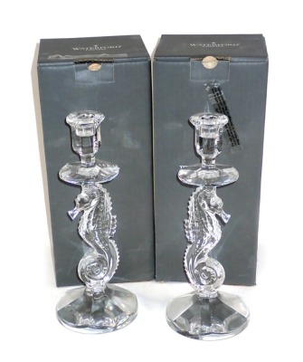 A pair of Waterford crystal candlesticks, each with a seahorse shaped column and a faceted tapering foot, 29cm high, boxed.