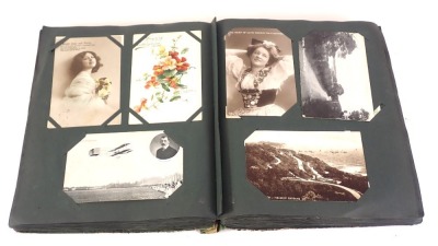 An album containing a large quantity of early 20thC postcards, to include race horses, real photo, actresses, places, etc.