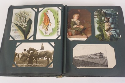 An album containing a large quantity of early 20thC postcards, to include race horses, real photo, actresses, places, etc. - 2