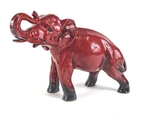 A Royal Doulton Flambe model of an elephant, printed mark in black to underside and signed Noke, 19cm wide.