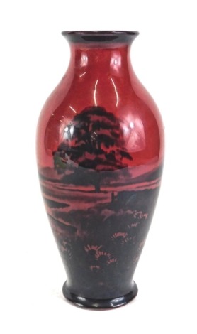 A Royal Doulton Flambe vase, decorated with a rural scene of cottage, etc., printed mark in black and decorators monogram to underside, 29cm high.