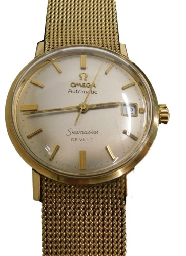 An Omega Seamaster De ville automatic gentleman's wristwatch, with a rose gold coloured dial with gold markers, on a pleated bracelet, stamped 975, the dial 3cm wide, 63.9g all in, boxed.