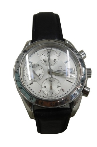 An Omega Speedmaster gentleman's chronograph wristwatch, with a silvered dial with date aperture, in stainless steel casing on a black leather strap, boxed.