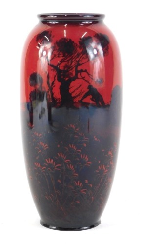 A Royal Doulton Flambe bullet shaped vase, decorated in silhouette, etc., with a ploughing scene, printed marks in black to underside, 22cm high.