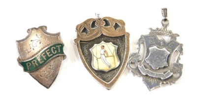 Three various fobs, one silver, another enamel silver gilt Gymnastics fob, 4cm high, and a plated Prefect fob brooch, 26g all in. (3)