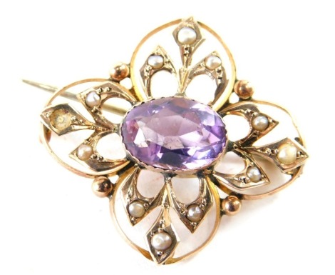 An Edwardian amethyst brooch, the oval stone in a pierced floral surround, set with seed pearls, with plain pin back, 4cm wide, in red Moroccan leather case.