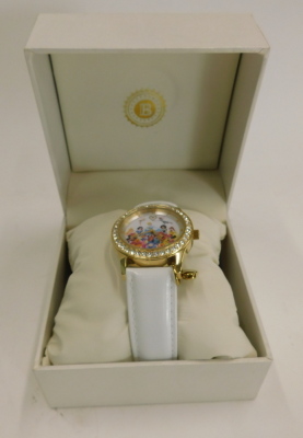 A Bradford Exchange Disney Believe in Magic wristwatch, depicting the classic Disney figures, on a white leather strap, the dial 3cm wide, boxed. - 2