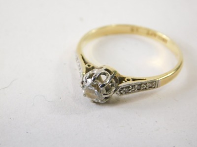 An 18ct gold platinum and diamond dress ring, claw set with single stone, flanked by small white stones to the shoulders, marked 18ct plat, size N. (cased) - 2