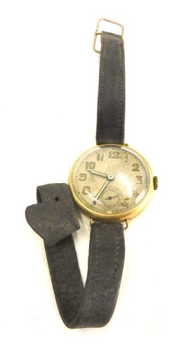 An 18ct gold cased wristwatch, with a circular painted numeric dial and seconds dial, with a fifteen jewel Swiss movement, with serial number 406672, London 1928, 2.5cm wide, on brown leather strap, 21.5g all in.