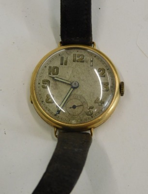 An 18ct gold cased wristwatch, with a circular painted numeric dial and seconds dial, with a fifteen jewel Swiss movement, with serial number 406672, London 1928, 2.5cm wide, on brown leather strap, 21.5g all in. - 2