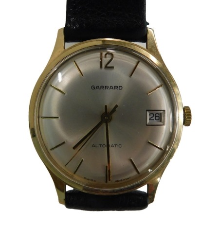 A Garrard gold plated gentlemen's wristwatch, with silvered coloured numeric dial with date aperture, black leather strap, the dial 3cm wide, boxed.