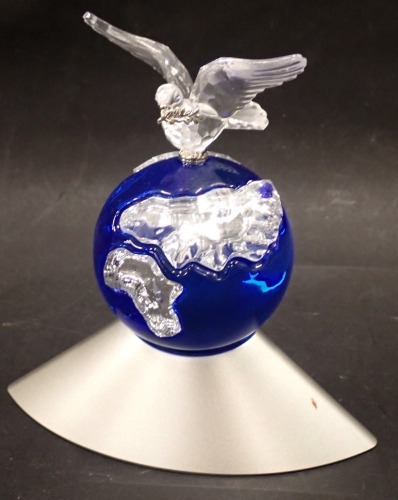 A Swaroski crystal Dove of Peace figure, depicting a dove on blue globe with chrome base, 12cm high.