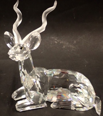 A Swarovski crystal figure of a seated antelope, 11cm high, boxed.