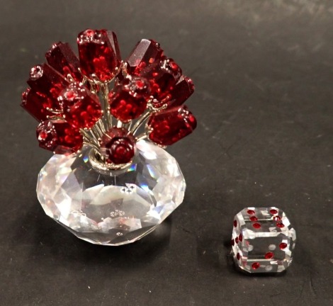 Two items of Swarovski crystal, comprising a basket of red roses, 6cm high, and a six sided dice, 1.5cm wide. (2, boxed)