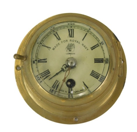 A brass cased ship's clock or timepiece, stamped to the dial Made For Royal Navy, London, 13cm diameter.