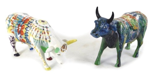 A Cow Parade ceramic figure of a cow, decorated with multi coloured design, and another similar. (2)