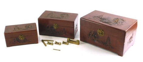 A Chinese hardwood jewellery box, with carved decoration, 30cm high, and two similar smaller examples.