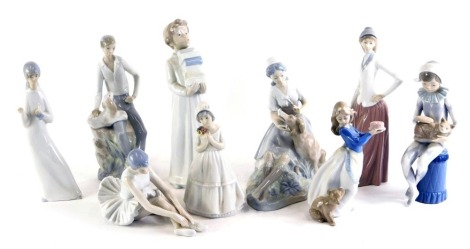 A collection of Nao porcelain figurines, to include girl with a dog, a young child dressed as a Harlequin with cat, child with books, etc. (some pieces AF)