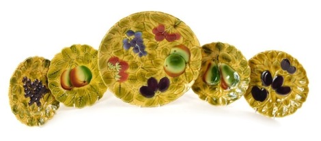 A Sarreggemines ceramic fruit plate, with relief moulded decoration, 27cm diameter, and four smaller plates.