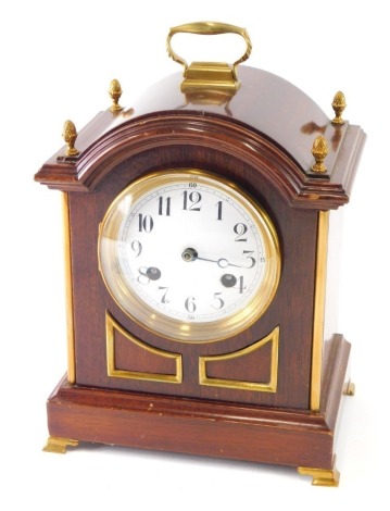 A late 19thC mahogany bracket clock, the 11cm diameter enamel dial surmounted with pineapple finials, with Arabic numerals, on bracket feet with giltwood embellishments, with eight day movement striking on two gongs, 27cm high.