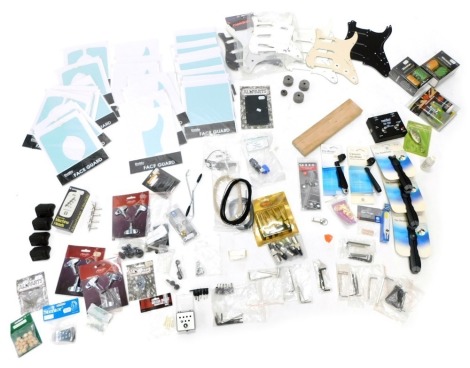 A quantity of guitar accessories, to include domo face guards, guitar polish kits, head stands, etc.