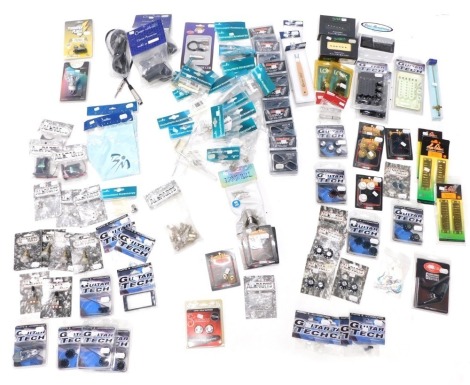 A quantity of guitar accessories, to include a Crafter bridge pin remover, a Piezo transducer, a Jiovanni custom crafted electric and bass guitar pickups, etc. (1 box)