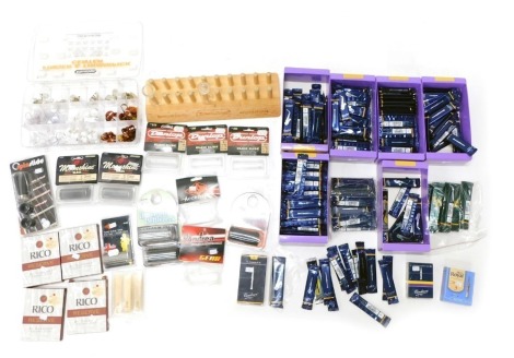 A quantity of musical instrument accessories, to include saxophone reeds, guitar finger and thumb picks, etc.