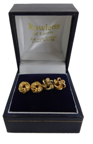 Two pairs of 9ct gold stud earrings, comprising pair of knot design and a pair of flower design with white stone centre, 3.3g all in. (2)