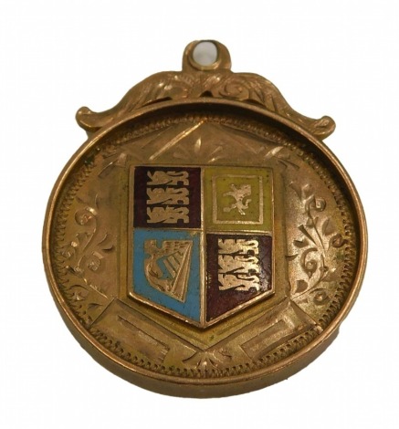 A 9ct gold shield fob, with scroll top, and an enamel central shield, with blue, red and yellow enamel, inscribed NL and D AR League 1909-1910, 5.7g.