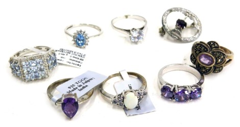 Seven silver stone set dress rings, and a silver plated thistle brooch, 29.5 all in.