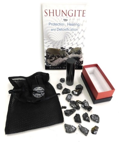 A Shungite bar, collectors book and guides, and various loose beads.