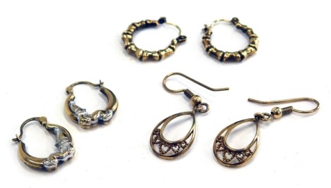 Three pairs of 9ct gold earrings, comprising a pair of 9ct gold hoops, hoops with clowns bicolour, and two basket drops, 3.5g all in. (6)