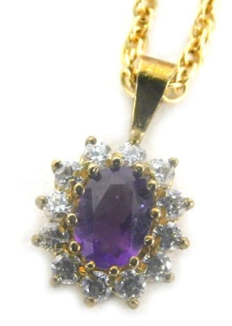 An amethyst pendant, claw set with an oval stone surrounded by small white stones, attached to a slender link 9ct gold necklace, 42cm long, 4.2g all in, cased.