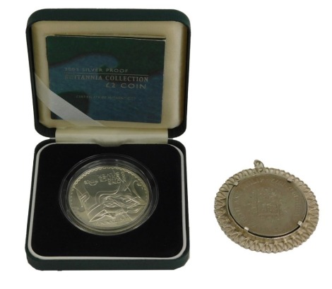 A silver circular coin pendant, with central heart, and heart fluted border, together with a 2003 silver proof Britannia two pound coin, boxed. (2)