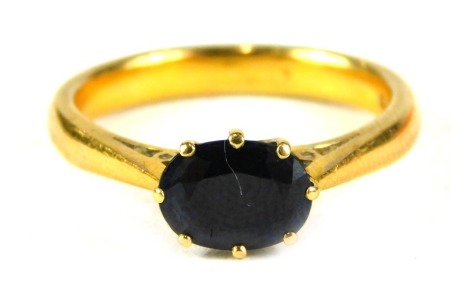 A 22ct gold sapphire dress ring, with oval sapphire in eight single claw setting, ring size O½, 5.3g all in.