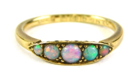 An 18ct gold opal gypsy ring, the central shape set with five opals, on a plain band, ring size L½, 2.6g all in, boxed.