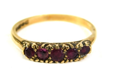 A 9ct gold dress ring, set with five garnets, on plain band, ring size P½, 2.1g all in.