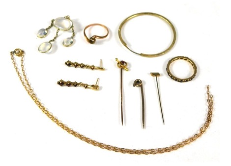 A collection of jewellery, comprising a moon stone pendant, 9ct gold chain, plated earring, 9ct gold ring stand, 9ct gold eternity ring set with garnets, pair of 9ct gold drop earrings, and a stick pin stamped 15ct, 7.6g all in. (a quantity)