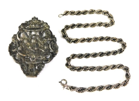 A curb link silver neck chain, 40cm long, and an Eastern white metal nurses buckle, depicting a scene with child, unmarked, 5cm wide. (2)