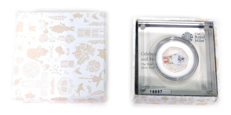 A Royal Mint Beatrix Potter Tailor of Gloucester silver proof fifty pence, no. 18897, boxed in outer case.