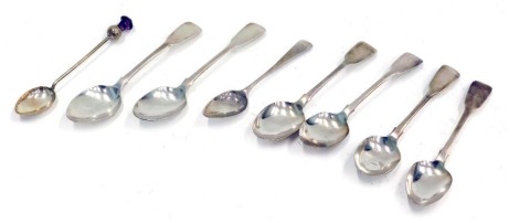 A matched set of six silver teaspoons, of plain design, a teaspoon bearing the initials JMC and a silver thistle topped spoon, with purple paste stone, 4.17oz. (8)