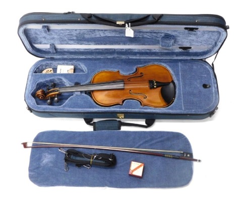 A Hidersine Giovanni three quarter sized violin, with label to interior, one piece back, in hard carrying case.