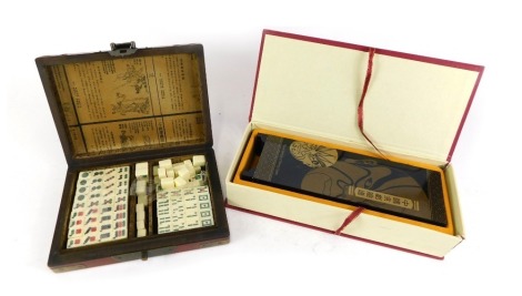 Oriental wares, comprising modern oriental mask panel screen, in presentation box and a red lacquer oriental cased Mahjong set. (2)