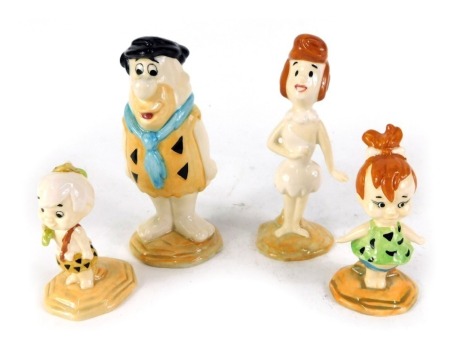 Four John Beswick Flintstone figures, comprising Pebbles Flintstone, Fred Flintstone, Bamm-Bamm Rubble, and Wilma Flintstone, boxed.